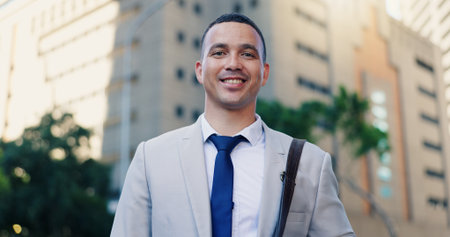 City, justice and smile with portrait man on street for commute to court for legal representation. Happy, law firm and trust with lawyer outdoor in urban town for travel to trial as consultantの写真素材