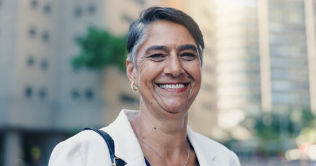 City, justice and portrait of lawyer woman on street for commute to court as legal counsel. Law firm, smile and trust with mature attorney outdoor in urban town for travel to trial as consultantの写真素材