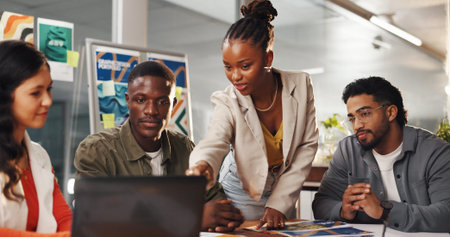 Creative people, meeting and laptop in office for graphic design, planning and research. Digital agency, communication and team with tech, social media or ideas for website or UI project homepageの写真素材