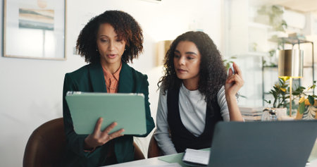 Business, help and women in office, tablet and teamwork with feedback for news report. People, journalist and employees in workplace, tech or online magazine with website review or planning for storyの写真素材