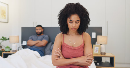 Frustrated couple, fight or disagreement with stress in bedroom for argument or toxic relationship. Upset man, woman or ignore with conflict in bed for breakup, divorce or cheating affair in homeの写真素材