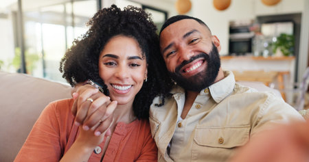 Couple, selfie and happy with portrait on sofa in home, love or connection with hug in lounge. Man, woman or embrace with smile for photography, profile picture POV or social media post in Costa Ricaの写真素材