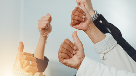 Business people, hands and thumbs up for collaboration, support or teamwork with goals. Employees, group and approval with gesture for mission, target and staff synergy for voice or positive opinionの写真素材