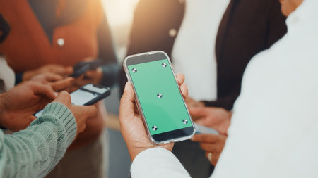 Green screen, hands and phone with business people in circle at work for communication or networking. Huddle, information transfer and mobile with employee team in office together for connectivityの写真素材