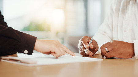 Signature, documents and hands of business people in office for deal, contract and agreement. Corporate, onboarding and workers with pen for paperwork for company form, partnership and applicationの写真素材