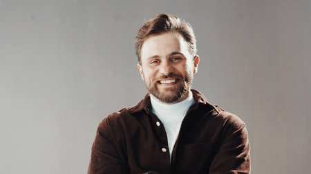 Smile, professional and portrait of businessman in studio with confidence for career development. Happy, male person and creative director from Italy with pride for job growth by gray background.の写真素材