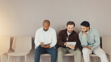 Tablet, recruitment and waiting room with business men for hiring, show cv or planning with space. Interview, queue and group of workers with technology for hr, discussion or help with applicationの写真素材