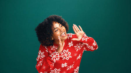 Excited, woman and announcement for Christmas, studio and awareness for holiday discount or festive. Green background, shout and attention for xmas special, December offer and black person with smileの写真素材