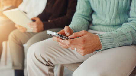 Hands, business and person with phone in waiting room for job interview, sign up and company...