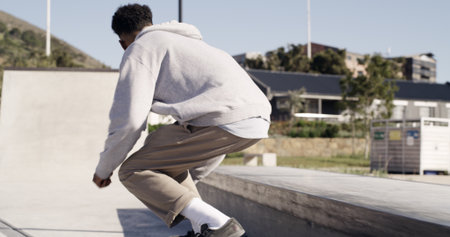 Man, skateboard and ramp in city, back and fitness with freestyle practice, sports and training. Person, skater and talent with stunt, outdoor and challenge with competition, balance and Canadaの写真素材