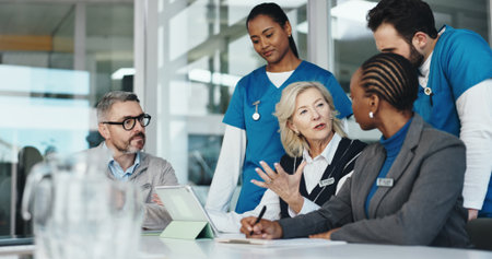 People, nurses and meeting with team in office for planning, medical report and feedback on operation. Woman, tablet and results for healthcare, surgery schedule and brainstorming of hospital fundingの写真素材