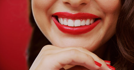 Teeth, lipstick and woman in studio for beauty, makeup and cosmetology with smile on background. Red...
