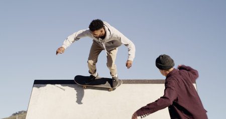 Man, skateboard and trick on ramp at park with friends, outdoor and culture with streetwear in city....