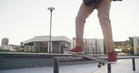 Skateboard, legs and balance on rail at skatepark for grind stunt, training performance or workout....