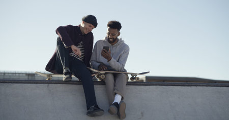 Phone, streaming and search with friends at skate park for social media, learning tricks and relax....