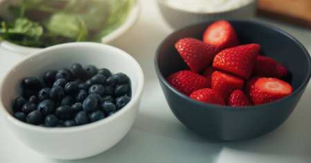 Strawberries, blueberries and bowl with fruit for diet, nutrition or natural organic meal prep. Closeup, vitamins and ingredients with fiber for healthy breakfast, vegetarian food or recipe in homeの写真素材