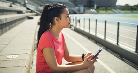 Athlete, woman and thinking with phone at stadium for social media, fitness app and event agenda....