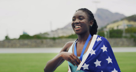 Runner, girl and medal with USA flag, smile or excited for success with goals at global event. Black woman, athlete and champion with national pride, achievement or sport contest at stadium in summerの写真素材