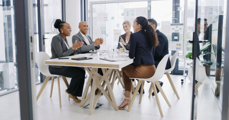 Applause, support and teamwork with business people in meeting for revenue, profit report and success. Budget proposal, investment portfolio and celebration with employees in office for bonusの写真素材