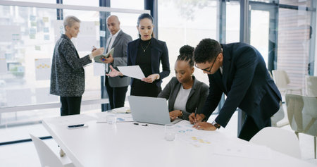 Writing, finance paperwork or business people in office for development, planning or teamwork. Charts, document or financial analysts in meeting for solution, brainstorming or collaboration projectの写真素材