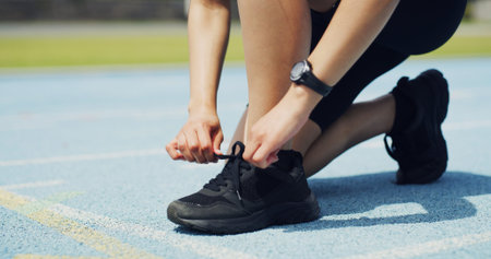 Fitness, shoes and hands of person on track for running, workout or training for race outdoor....