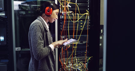 Cybersecurity, testing and woman on tablet for maintenance, repair and inspection in server room....