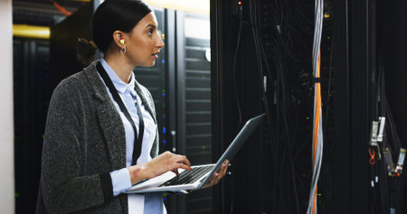 Database, maintenance and woman with laptop in control room for technical support in office....