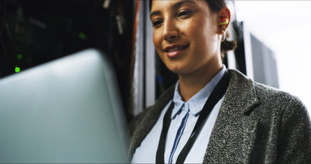 Cybersecurity, testing or woman on laptop for engineering, repair or inspection in server room. Information technology, programming or IT technician with data for maintenance, backup or control panelの写真素材