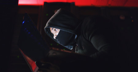 Technology, hacker and person with mask at night for coding scam, phishing or cybercrime in dark....