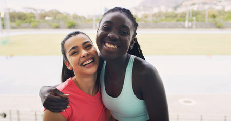 Friends, laugh and portrait in stadium for fitness, marathon and sport field. Women, athlete and hug...