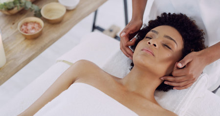 Woman, zen and hands for face massage in salon for beauty, spa and skincare for wellness. Masseuse,...