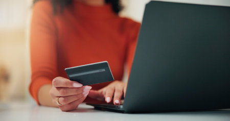 Woman, hands and credit card with laptop for online shopping, payment or banking in home. Closeup,...
