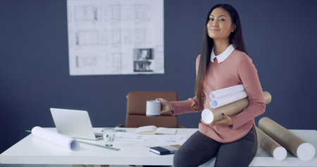 Blueprints, coffee and portrait of architect woman in office for planning or property development. Construction, documents and drink with Asian engineer in workplace for design or project managementの写真素材