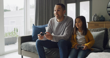 Father, kid and play video game in home for competition, contest and entertainment on sofa. Happy...