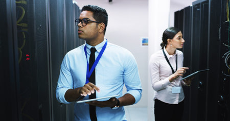 Man, woman and tablet in server room, storage and checklist on app for IT solution at company....
