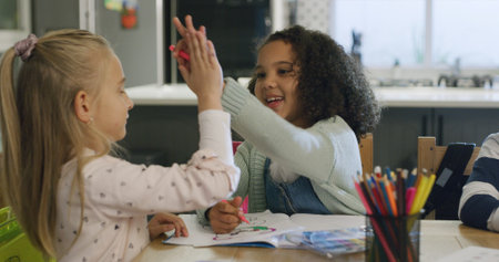 Happy girl, friends and drawing with high five in classroom for creative learning success in school....