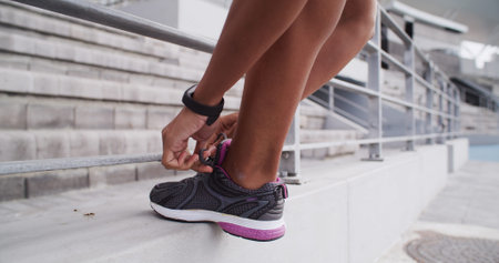 Athlete, hands or shoes with lace at stadium for marathon practice, running comfort or start...