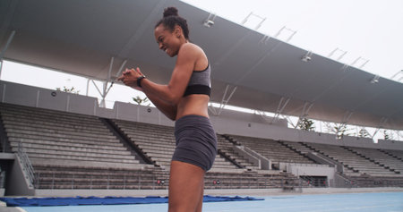 Athlete, woman and applause to celebrate on sports track for fitness, win and achievement outdoor....