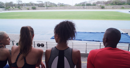 Outdoor, athlete and people on break, bleachers or team at stadium for competition or communication....