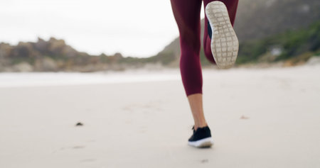 Running, legs and space with woman at beach for health, cardio workout and sports training. Marathon...