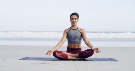 Woman, meditation and lotus at beach, breathing and mindfulness with space, sky and zen in summer....