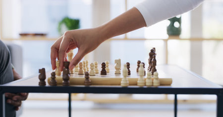 Chess, hand and strategy with business person in office for competition or mental aptitude. Critical...
