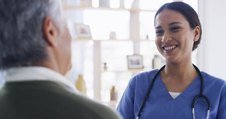 Happy nurse, home and talk with senior woman for healthcare, medical wellness or homecare. Smile, caregiver and conversation with elderly patient for good news, diagnosis or help with assisted livingの写真素材