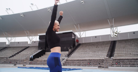 Happy, athlete and woman at stadium, celebration and cheering for complete fitness goal and success....