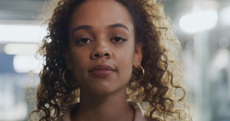 Night, employee and woman in office, portrait and confident for career development or job promotion. Working late, reporter and person with pride for opportunity, serious and ambitious in newsroomの写真素材