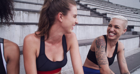 Sports, happy friends and women relax at stadium, laughing or fitness with runners outdoor together....