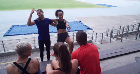 Couple of friends, athlete and funny people at stadium for sports break, talking and fitness at...