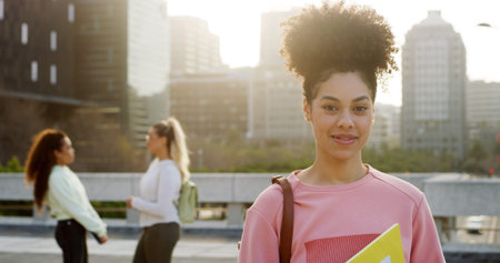 Happy woman, portrait and university student with books, pride and back to school in city. Girl,...