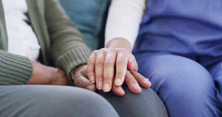 Senior care, holding hands and caregiver in nursing home, compassion and medical assistance or help....
