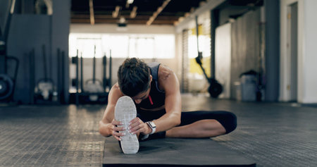 Stretching, legs and fitness with woman in gym for workout, health and strength training. Muscle...